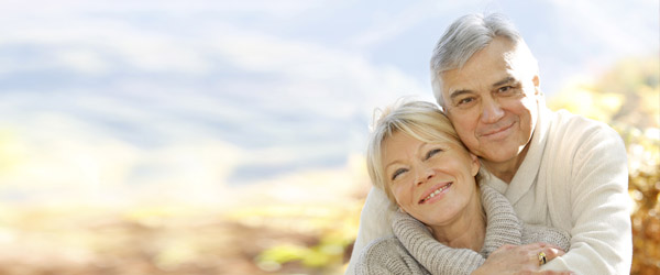 A husband hugging and smiling with his wife