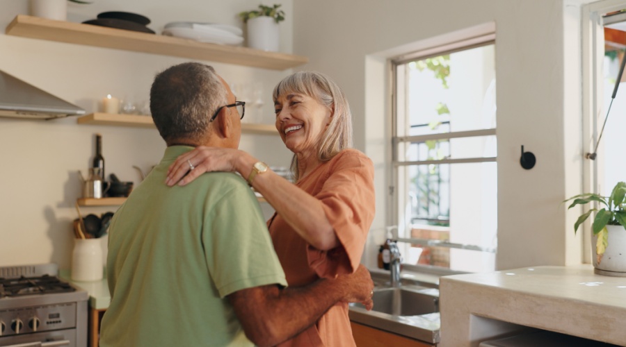 Elder couple dancing in kitchen