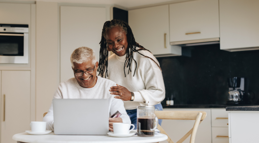 Happy old couple paying their reverse mortgage