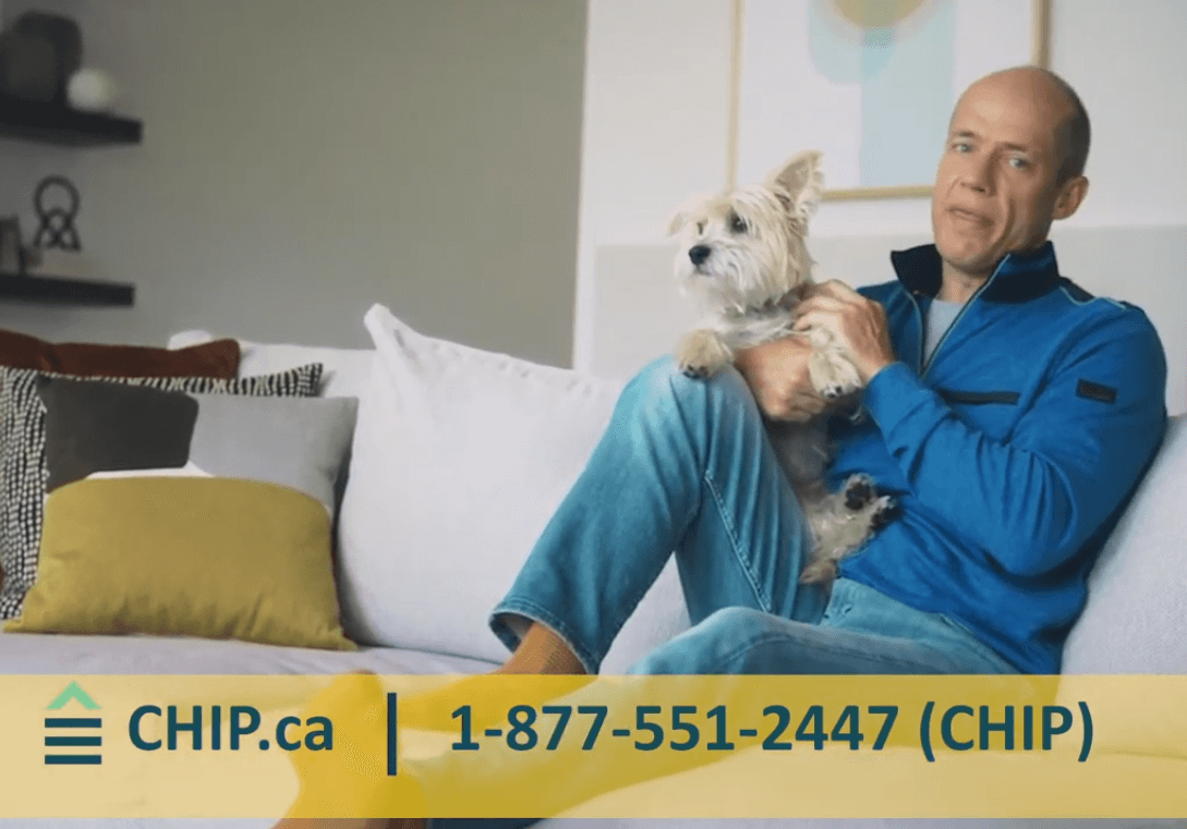 Kurt Browning holding a dog on a couch