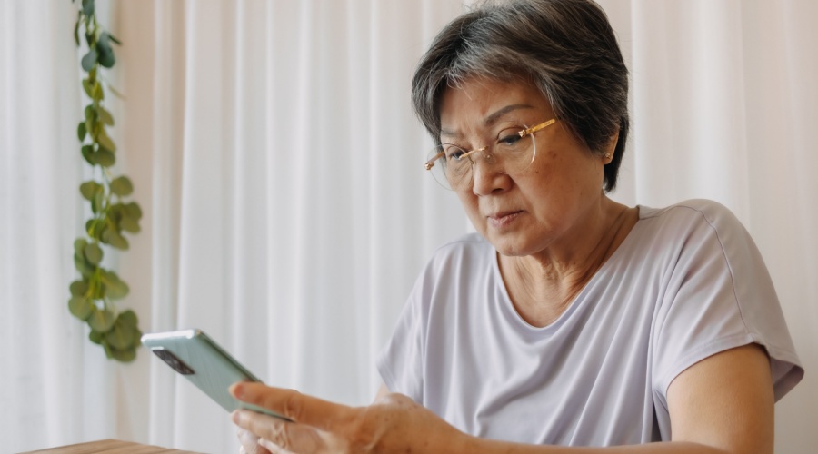 Older woman looks concerningly at her phone