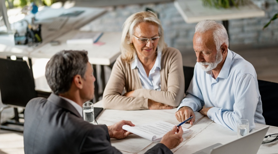 Senior couple talking to advisor