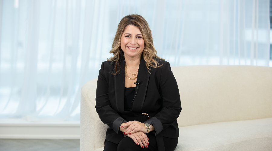 Vivianne-Gauci-HomeEquity-Bank's-CMO-and-SVP-sitting-and-smiling-at-the-camera