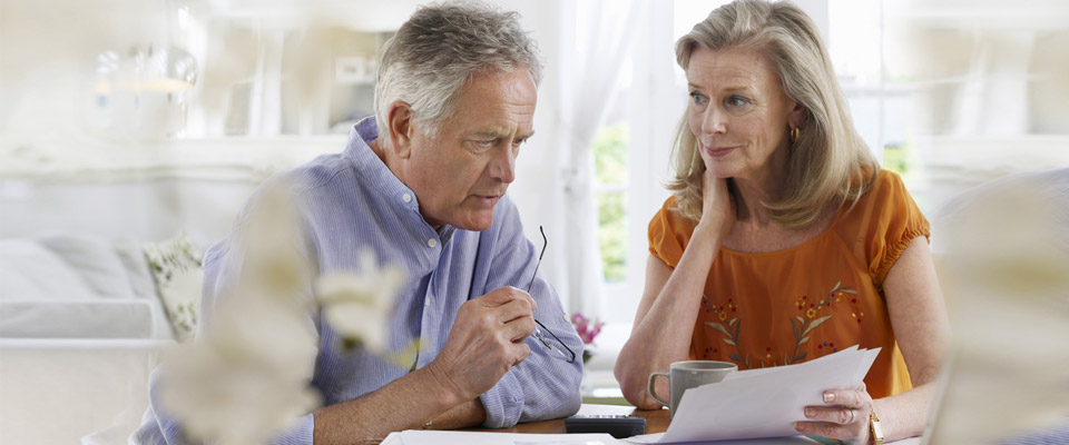 A senior couple discussing how they can plan ahead to lead a stress free retirement life.