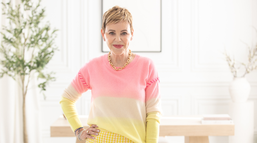 pattie-lovett-reid-smiling-at-camera-in-pink-and-yellow-outfit