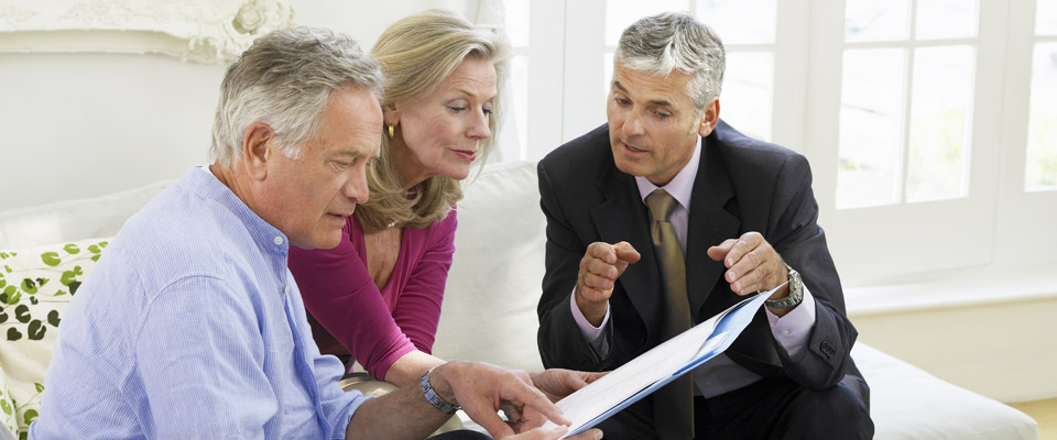 Canadian Senior couple discussing various options like downsizing and the CHIP Reverse Mortgage for extra funds.