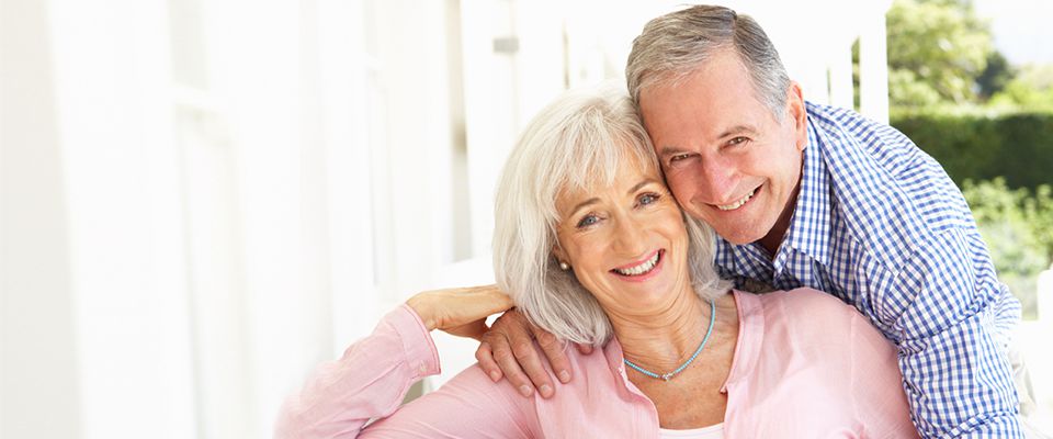 Senior Canadian retirees smiling and happy on securing a debt consolidation loan.